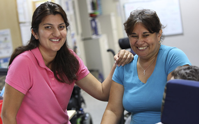 Photo of two Support Workers smiling